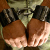 Male wrists bound with heavy steel Manicles